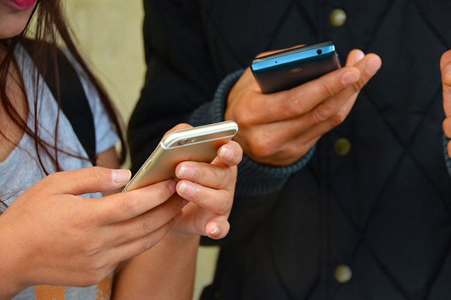 2 people holding cell phones